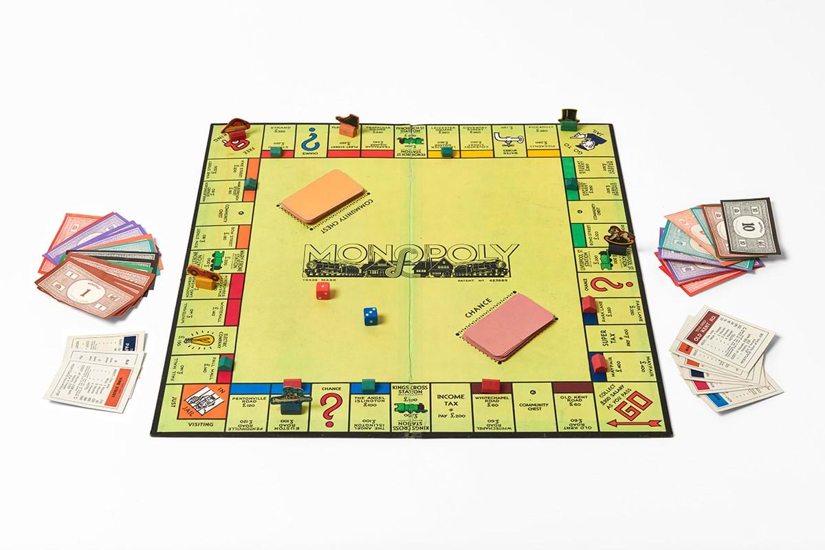 A monopoly set laid out on a white surface