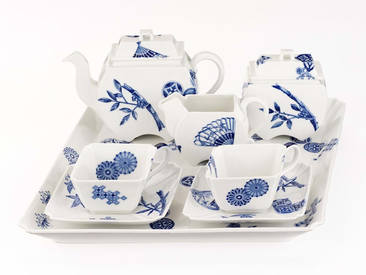 A tea set consisting of two cups with saucers, teapot, a small jug and sugar pot. White with blue patterns