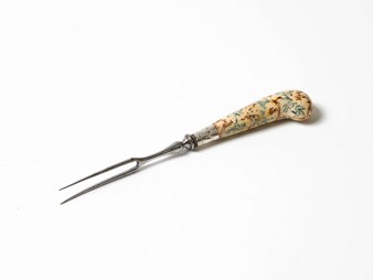 Metal fork with decorative cream handle