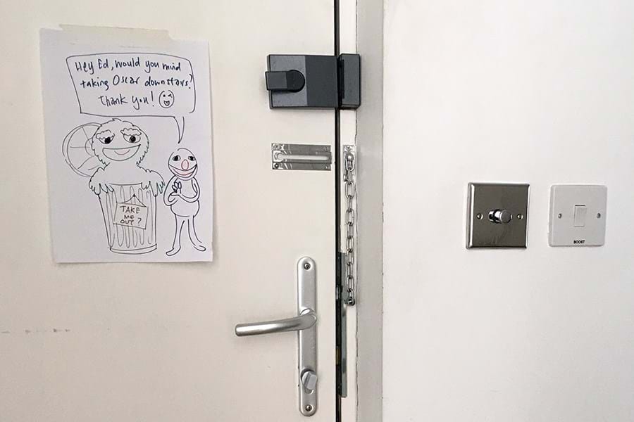 Cartoon of Sesame Street characters pinned to a white door