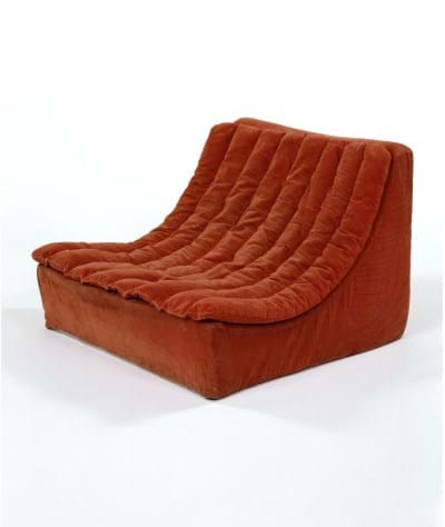 A low curved comfy seat covered in orange fabric