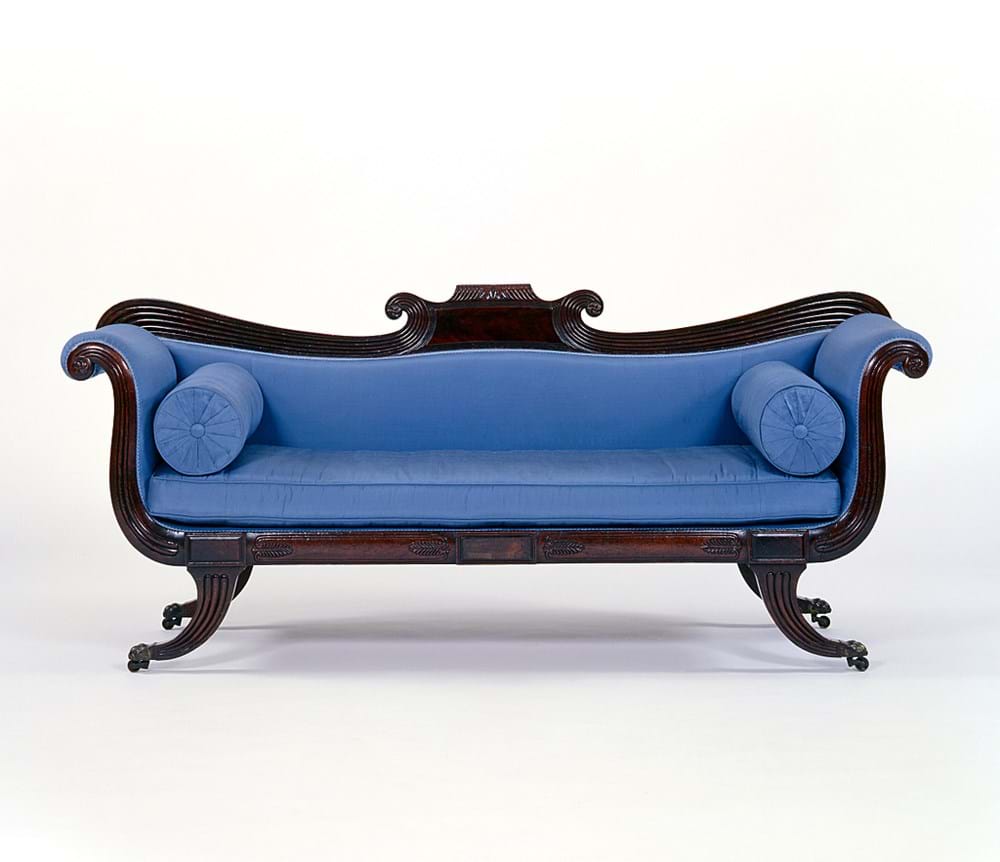 Blue sofa with ornate wood detailing