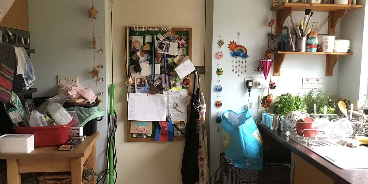 A kitchen with a noticeboard hanging on the wall