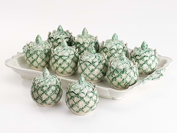 A set of  artichoke-shaped pots designed to serve custards.