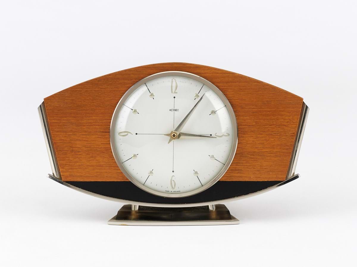 A clock set in brown and black wood