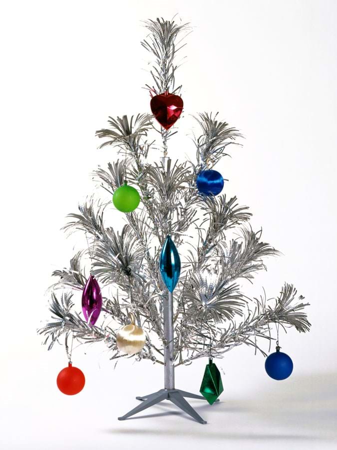 Silver artificial Christmas tree with baubles in different colours