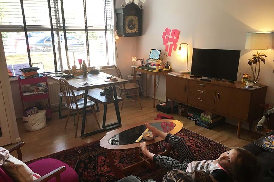 Child sitting on sofa with feet on a coffee table