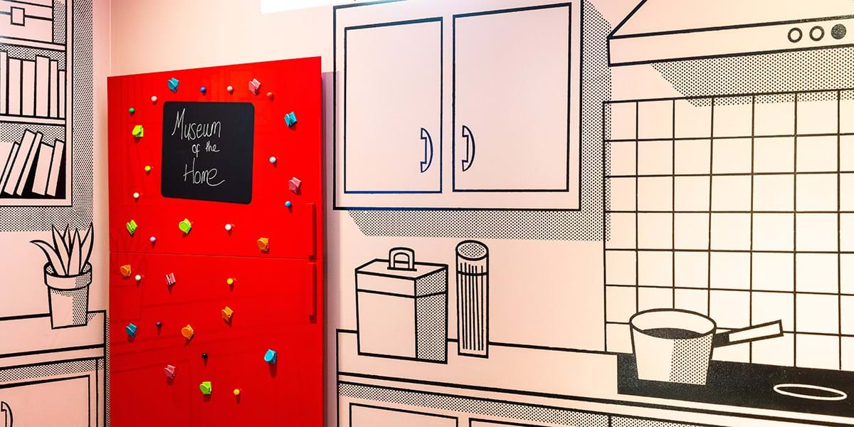 A wall with illustrated panels designed to look like a kitchen