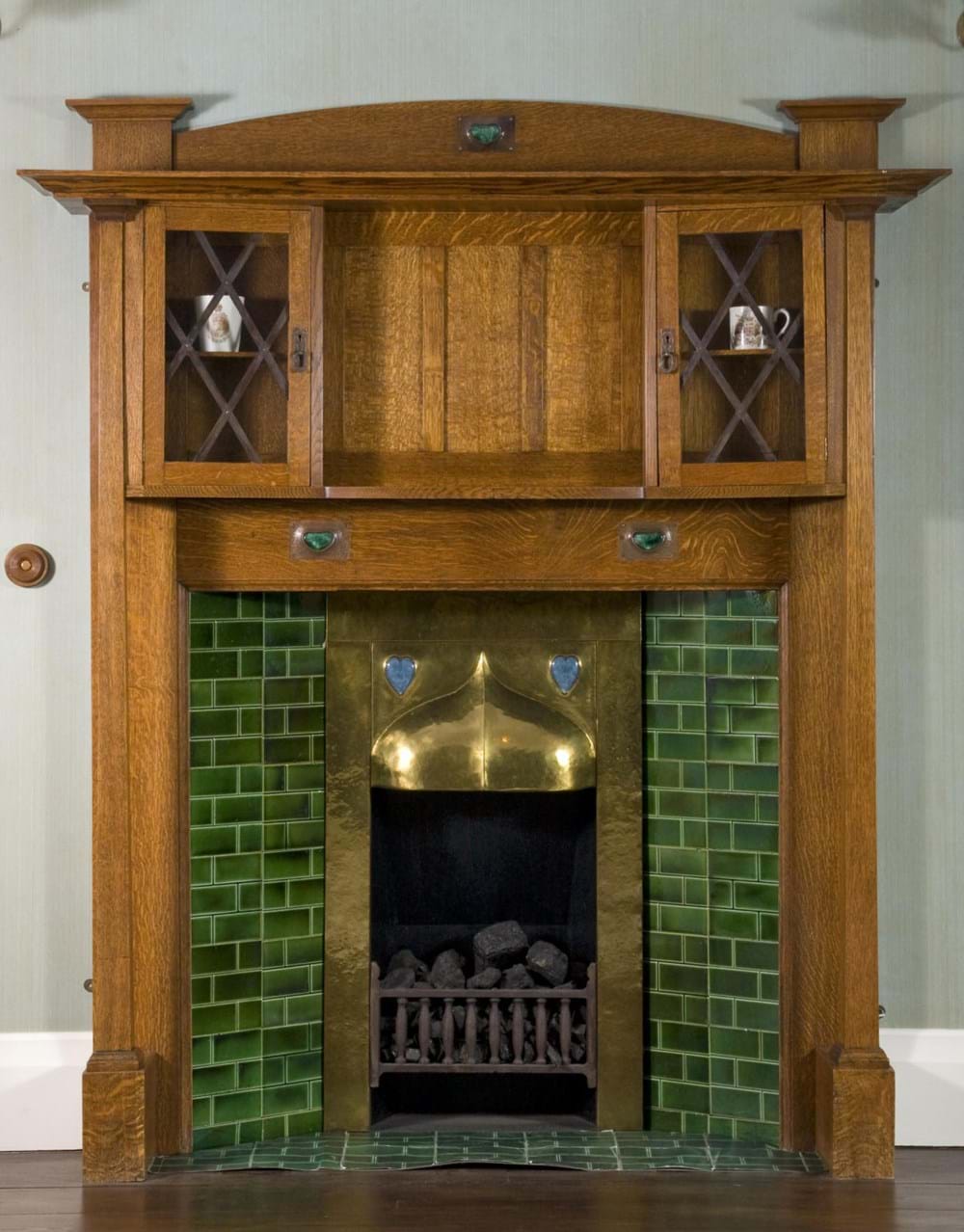 Wooden fireplace with green ceramic tiles