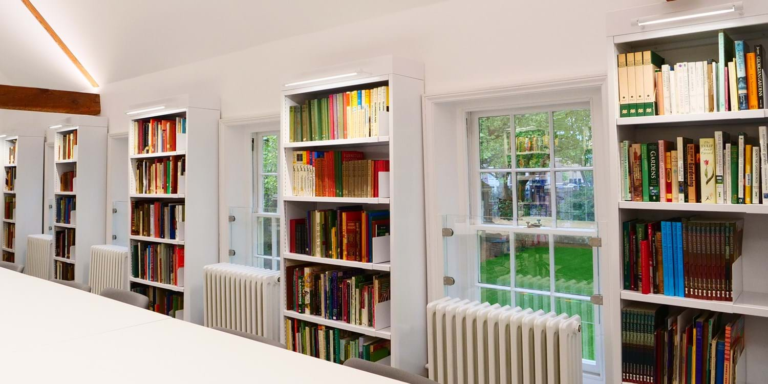 View of collections library with bookcases and windows showing the Kingsland Road Gardens