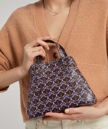 A hand bag with purple and brown patterned motif