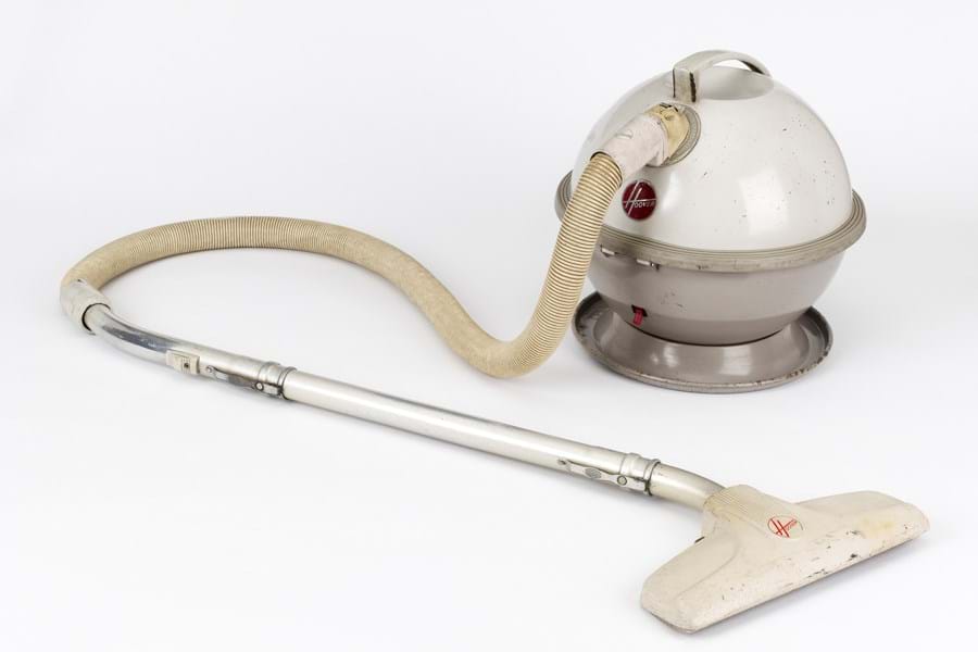 Cream plastic vacuum cleaner: with a spherical base and long tube