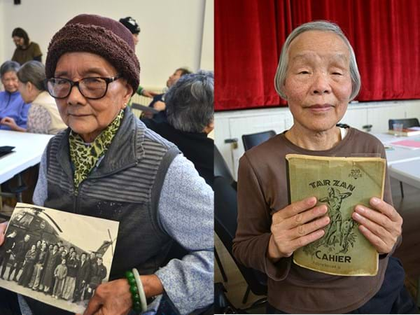 Two people holding up archival images and documents 