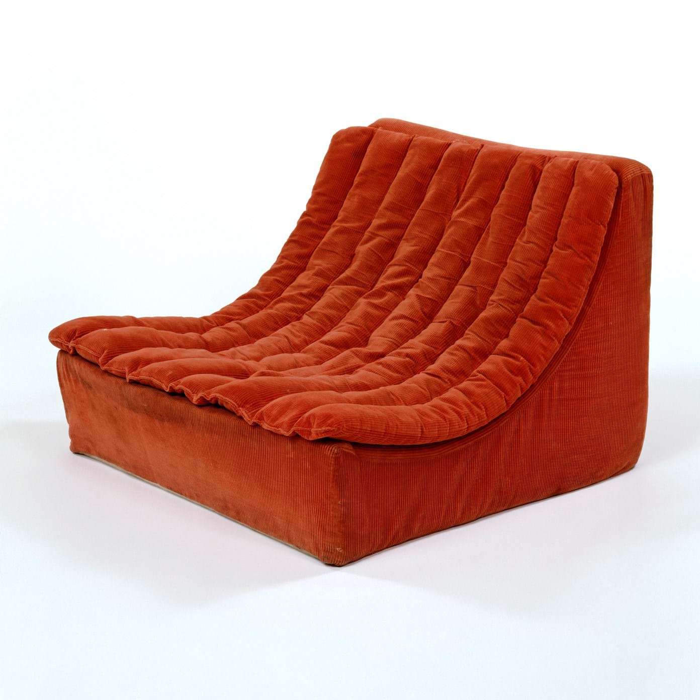 Curved chair in dark orange fabric