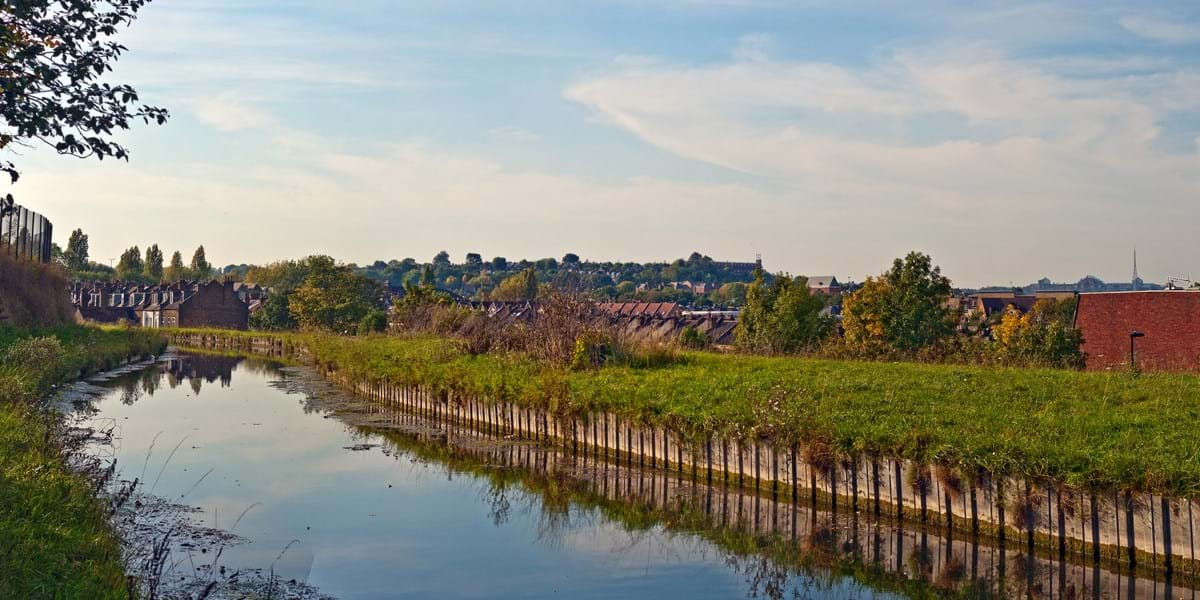 A view of a river with houses in the background