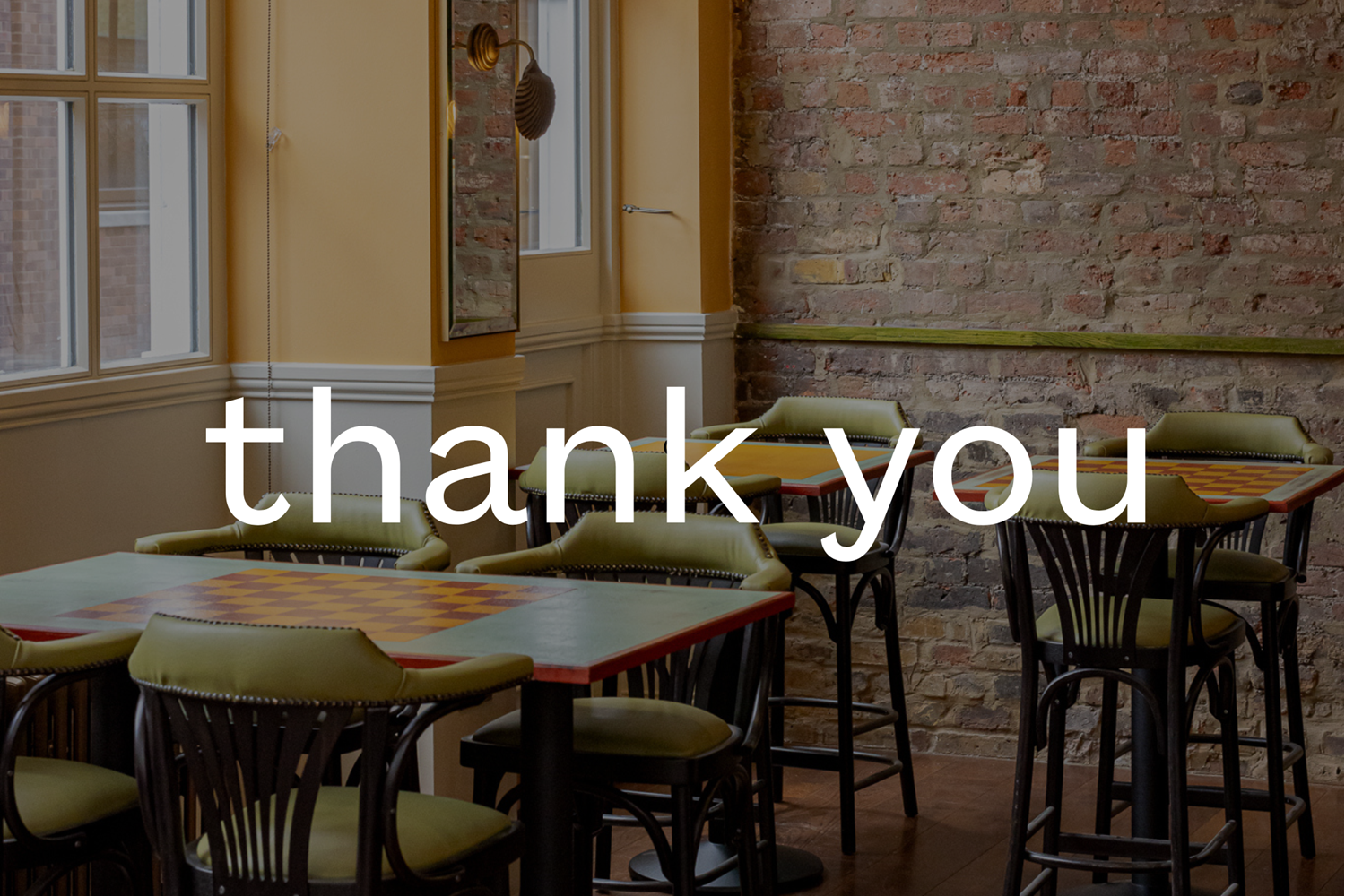 Image of empty cafe seats and interior with the words 'thank you' overlaid