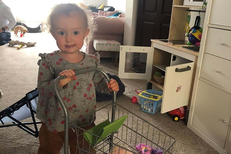 Child pushing a toy trolley