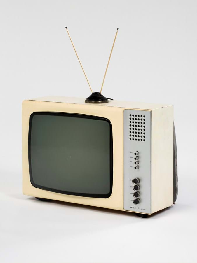 A cream television set with prominent antenna