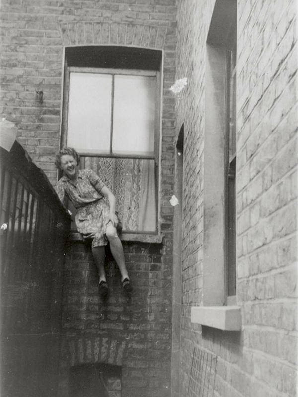 Edie Homes (nee Twine) climbing out of the second floor back room window