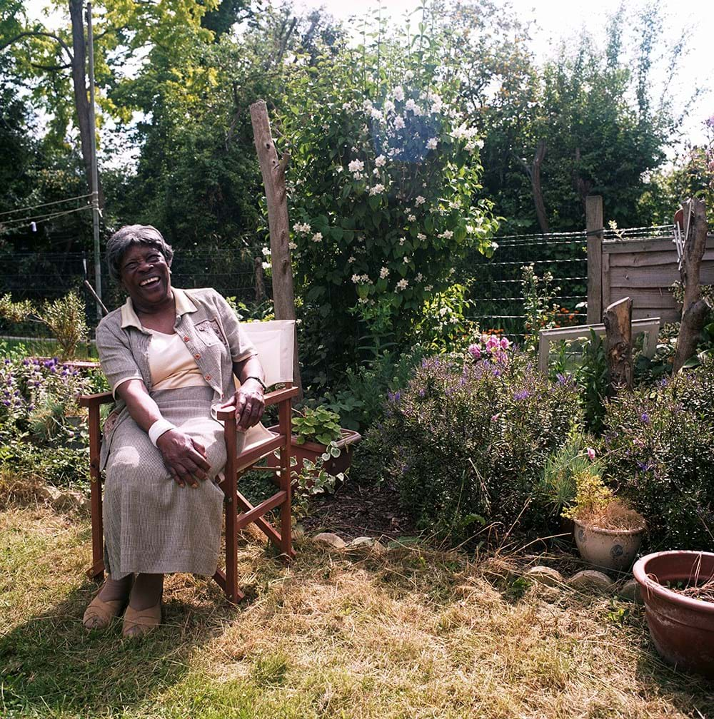 A person sat on a chair in a garden