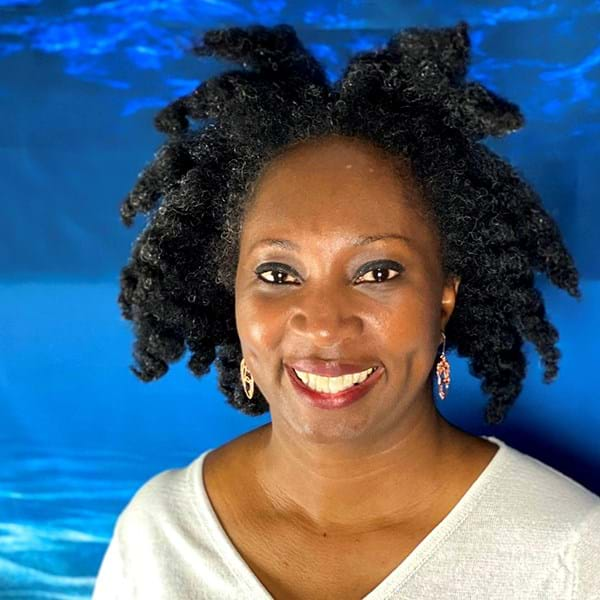 Wendy Shearer smiling with blue background