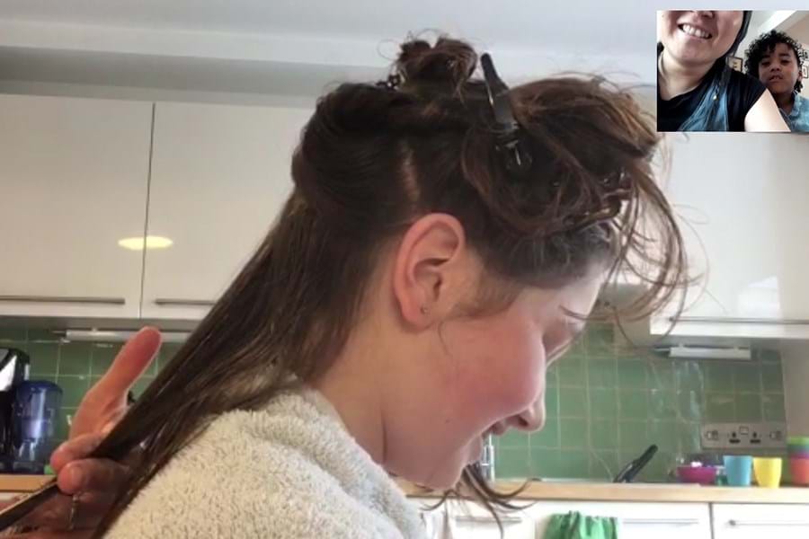 A person having their haircut via video call 