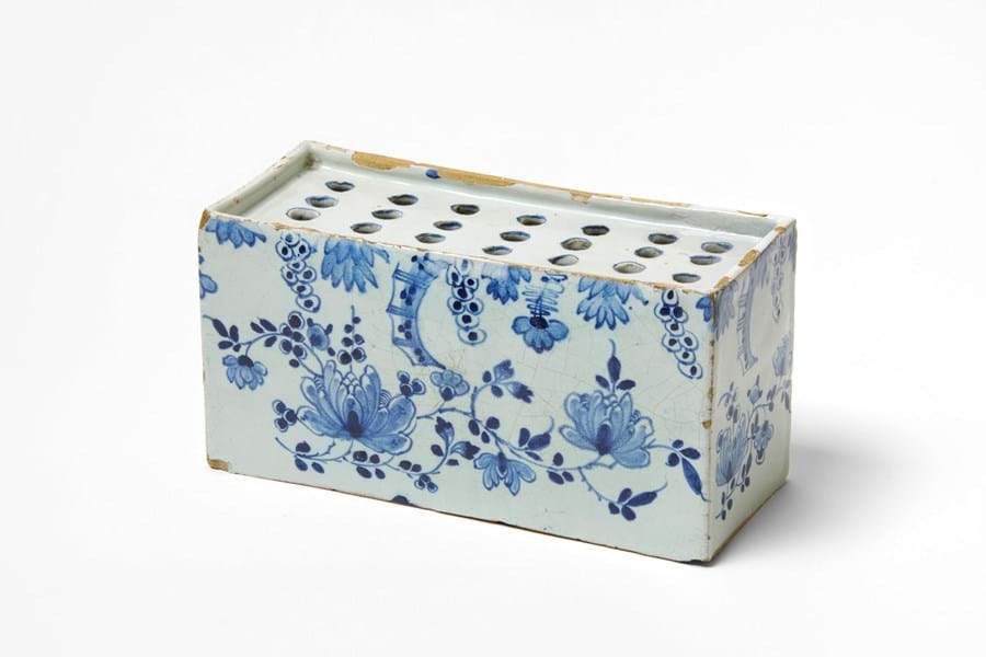 Blue and white brick with holes for flower stems