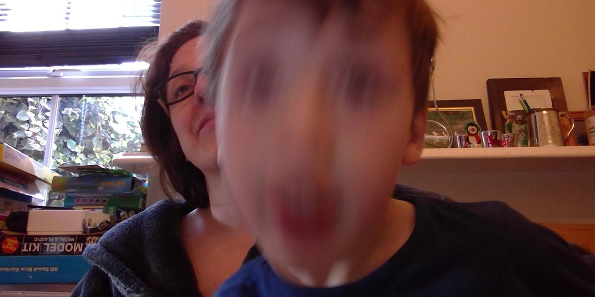 Blurry face of child in front of person