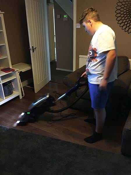 A person vacuuming the floor 