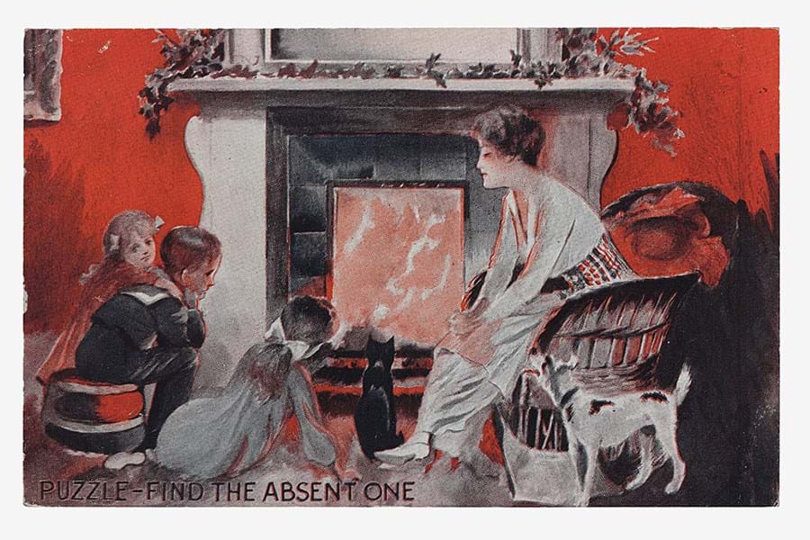 Edwardian postcard of a family sat around the fireplace