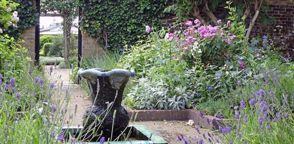 A herb garden with a fountain