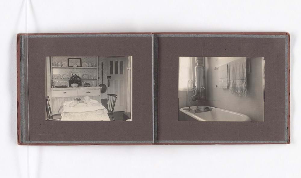 A photo album open to show two images of an apartment