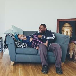 My time, my energy © Jonathan Donovan – father and son playing on sofa in living room