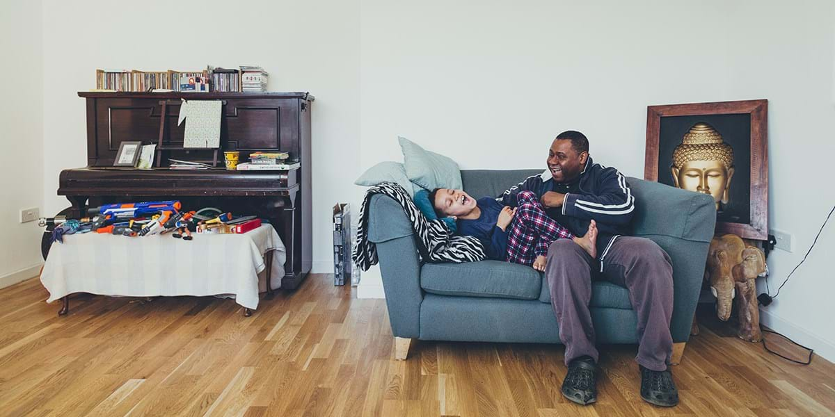 My time, my energy © Jonathan Donovan – father and son playing on sofa in living room