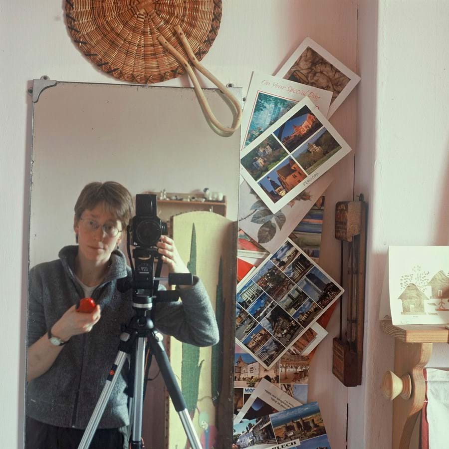 Self portrait of photographer in bathroom mirror