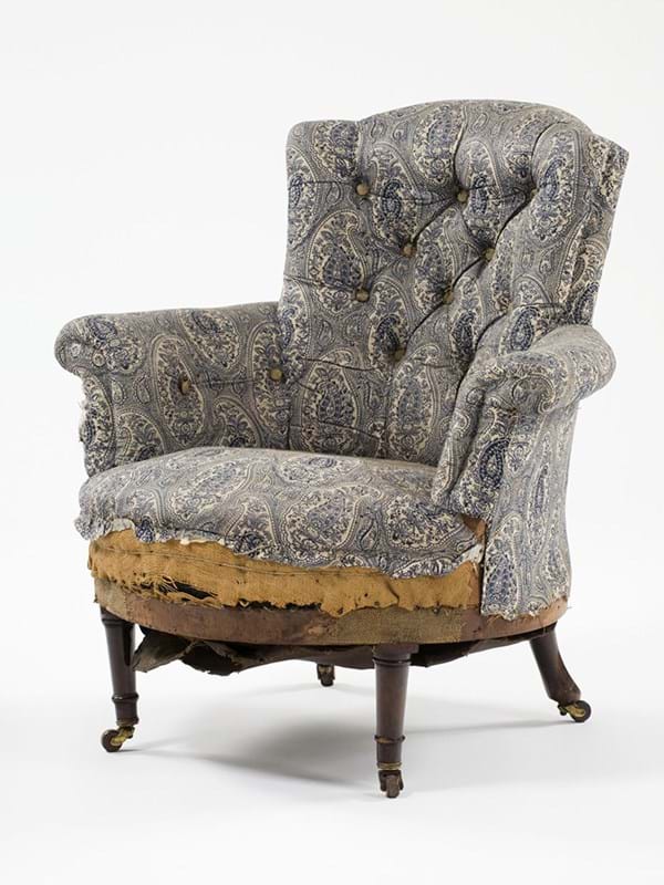 An arm chair covered in patterned fabric