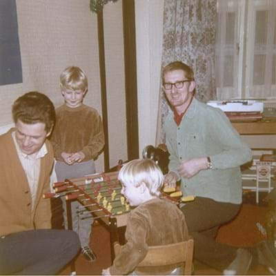 A group of people playing at a miniature football table 