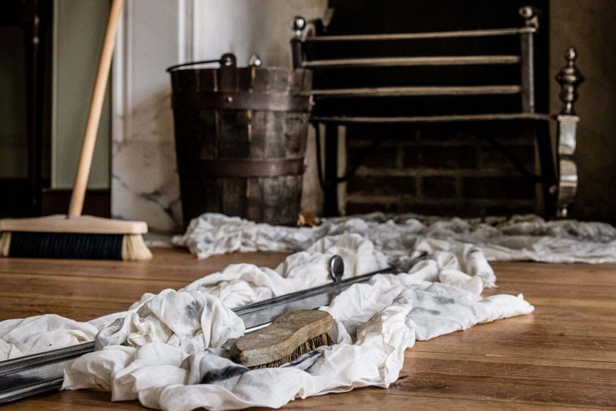 Tools for cleaning on a wooden fire in front of a fire place 