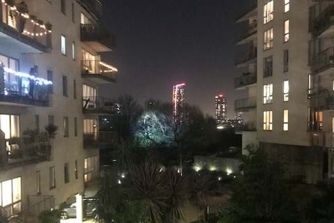 A view of balconies at night in a complex of apartment buildings