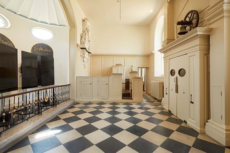 A chapel with checkered floor and beige walls