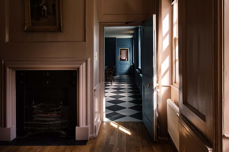 A view through an open door of a blue room