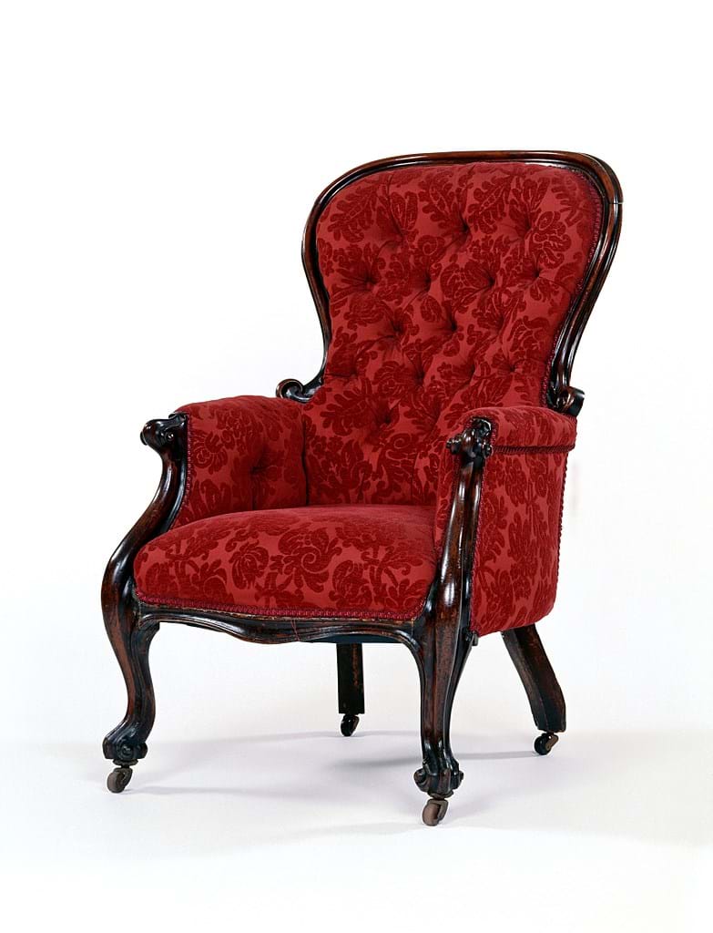 Wooden armchair with patterned red upholstery