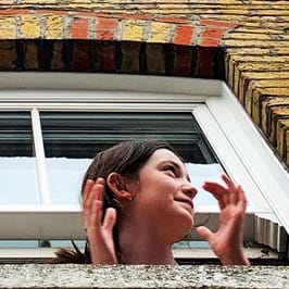 Person clapping out of an open window