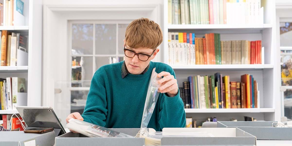 A person at a desk reading a book