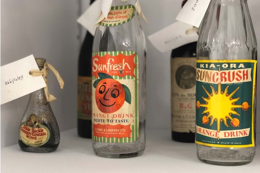 Vintage glass bottles with colourful labels 
