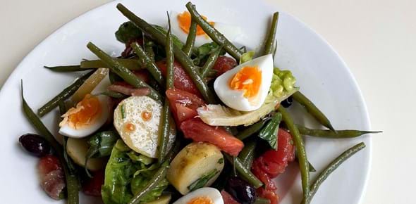 Plate of salad with green beans, potatoes and boiled egg