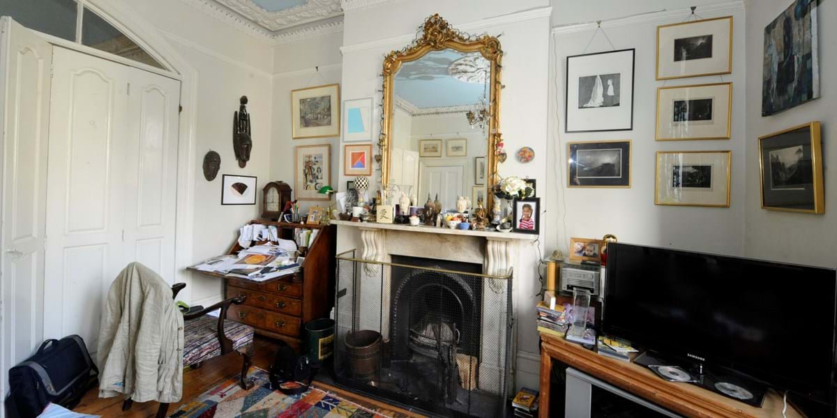 View of a living room with a large mirror on a mantelpiece