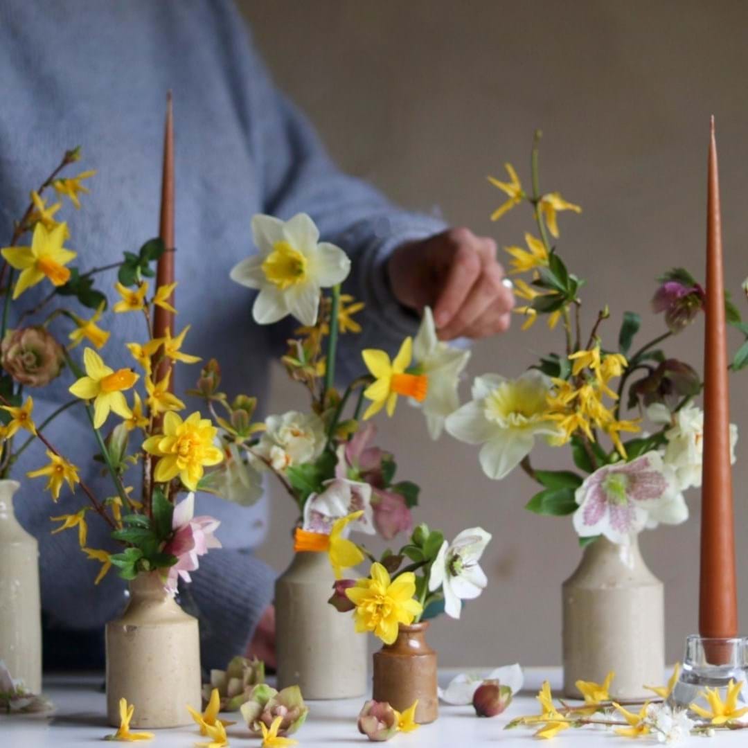 Daffodils in ceramic vases on a table