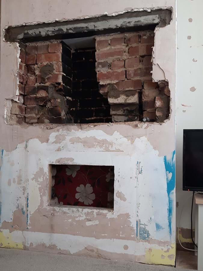 A hole in the plaster on an internal wall