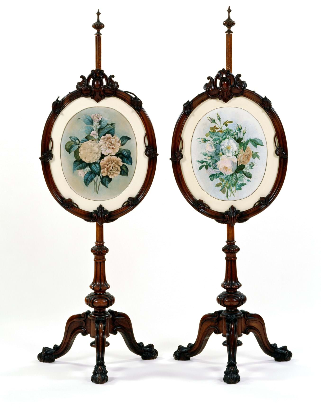 A pair of walnut fire screens with a floral decoration